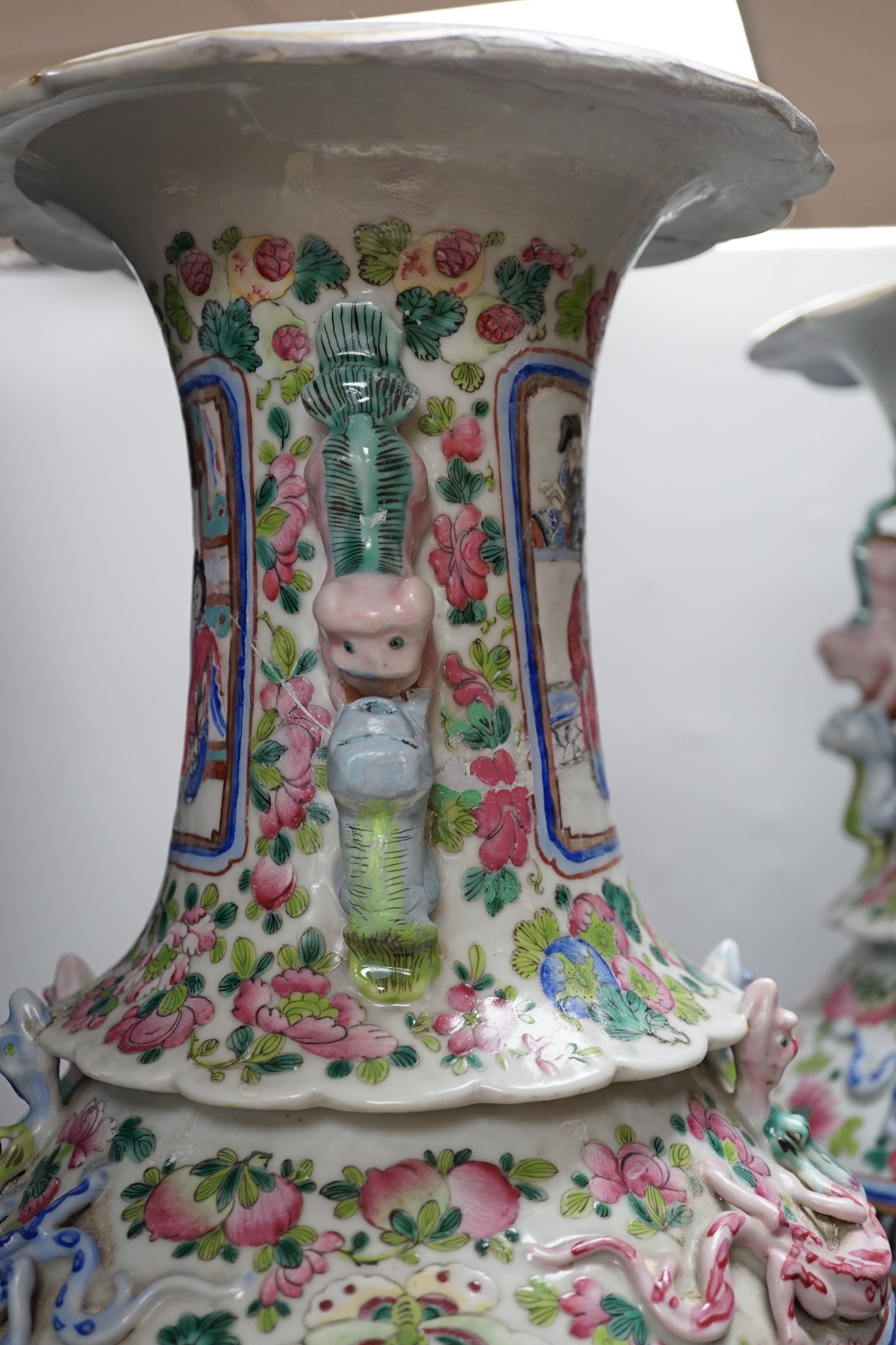 A pair of large Chinese porcelain famille rose vases, 19th century, decorated with court scenes and flowers, 61cm high